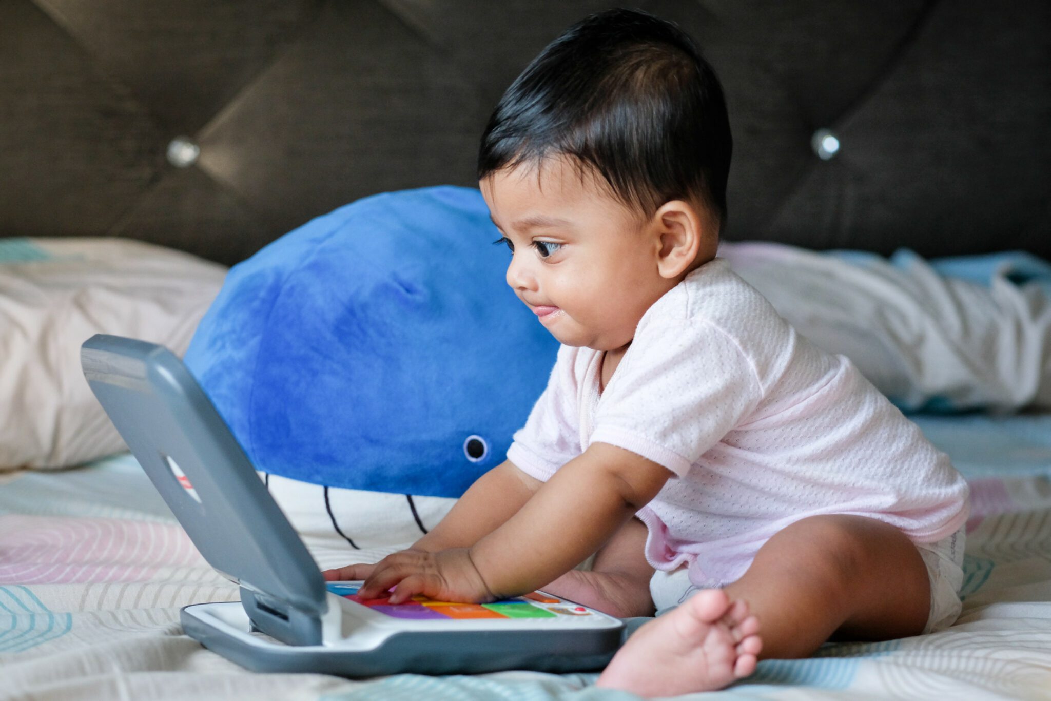 kid playing with toy computer